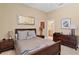 Bedroom features neutral paint, carpet, and adjoins an ensuite bathroom and wooden dresser at 3118 W Bay Villa Ave, Tampa, FL 33611