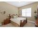 Cozy bedroom with neutral walls, comfortable carpet, and a large bright window at 3118 W Bay Villa Ave, Tampa, FL 33611