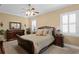 Inviting bedroom features neutral tones, a ceiling fan, and large windows with plantation shutters at 3118 W Bay Villa Ave, Tampa, FL 33611