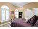 Comfortable bedroom features neutral walls, carpet, and arched windows with shutters at 3118 W Bay Villa Ave, Tampa, FL 33611