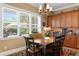 Bright dining area features a large window overlooking the yard and elegant chandelier at 3118 W Bay Villa Ave, Tampa, FL 33611