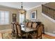 Formal dining room features a large wooden table with seating for eight and staircase view at 3118 W Bay Villa Ave, Tampa, FL 33611