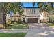 Charming two-story house showcasing a well-maintained lawn and an attached garage at 3118 W Bay Villa Ave, Tampa, FL 33611