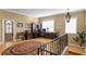 Upstairs home office with wooden floors and a wrought iron staircase railing at 3118 W Bay Villa Ave, Tampa, FL 33611