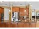 Granite island in kitchen with a sink, stainless steel appliances, and custom wood cabinets at 3118 W Bay Villa Ave, Tampa, FL 33611