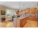 Spacious kitchen boasts a large island, hardwood floors, stainless steel appliances, and an adjacent dining area at 3118 W Bay Villa Ave, Tampa, FL 33611