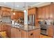 Granite island in kitchen featuring stainless steel appliances, cabinetry, and wine refrigerator at 3118 W Bay Villa Ave, Tampa, FL 33611
