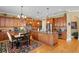 Spacious kitchen featuring wooden cabinetry, granite countertops, a large island, and stainless-steel appliances at 3118 W Bay Villa Ave, Tampa, FL 33611