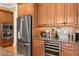 Gourmet kitchen featuring built-in appliances, a wine refrigerator, and custom wood cabinets at 3118 W Bay Villa Ave, Tampa, FL 33611
