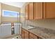 Functional laundry room with modern washer, dryer, sink, and ample cabinet space at 3118 W Bay Villa Ave, Tampa, FL 33611