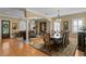 Open-concept living and dining area showcasing wood floors, ornate lighting, and large windows at 3118 W Bay Villa Ave, Tampa, FL 33611