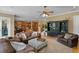 Open-concept living room showcasing hardwood floors, leather furniture, and seamless flow to kitchen at 3118 W Bay Villa Ave, Tampa, FL 33611