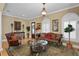 Cozy living room showcasing hardwood floors, a sofa and chair set, ornate lighting, and large windows at 3118 W Bay Villa Ave, Tampa, FL 33611