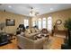 Bright living room with hardwood floors, arched windows, and a ceiling fan at 3118 W Bay Villa Ave, Tampa, FL 33611
