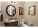 Charming powder room featuring granite countertop, decorative mirror, and unique wall art at 3118 W Bay Villa Ave, Tampa, FL 33611