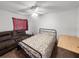 Spare bedroom featuring a sofa, a metal bed frame, and a desk, with neutral tones at 1009 Sagamore Dr, Seffner, FL 33584