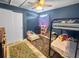 Playful bedroom with a bunk bed, toddler bed, toy storage and blue walls at 1009 Sagamore Dr, Seffner, FL 33584