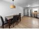 Dining area featuring a modern light fixture, a dark table, and stainless appliances at 1009 Sagamore Dr, Seffner, FL 33584