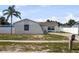 View of a single-story home with a palm tree in a well-maintained lawn at 1009 Sagamore Dr, Seffner, FL 33584