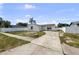 Charming single-story home featuring a driveway, fenced yard, and a lovely palm tree adding curb appeal at 1009 Sagamore Dr, Seffner, FL 33584
