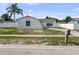 Charming single-story home with a palm tree and a well-maintained lawn at 1009 Sagamore Dr, Seffner, FL 33584