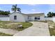 View of a charming single-story home with a palm tree and driveway at 1009 Sagamore Dr, Seffner, FL 33584