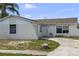 Charming single-story home with a white exterior, a front door, and a well-maintained exterior at 1009 Sagamore Dr, Seffner, FL 33584