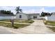Charming single-story home featuring a driveway, fenced yard, and a lovely palm tree adding curb appeal at 1009 Sagamore Dr, Seffner, FL 33584