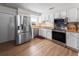Kitchen with stainless steel appliances, bright lighting and hardwood floors at 1009 Sagamore Dr, Seffner, FL 33584