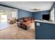 Cozy living room with blue walls, a ceiling fan, and hardwood floors at 1009 Sagamore Dr, Seffner, FL 33584