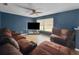 Living room featuring blue walls, hardwood floors, ceiling fan, and natural light at 1009 Sagamore Dr, Seffner, FL 33584