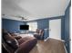 Living room with a ceiling fan, a window, hardwood floors, and blue walls at 1009 Sagamore Dr, Seffner, FL 33584