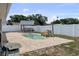 Backyard pool area featuring a white fence, gazebo, and a waterfall feature at 1009 Sagamore Dr, Seffner, FL 33584