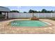 An in-ground pool is bordered by a brick paver deck and surrounded by a white vinyl fence at 1009 Sagamore Dr, Seffner, FL 33584
