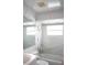 Bathroom area featuring a tub and shower combination, toilet, sink, and handicap bars at 101 Cambridge Trl # 205, Sun City Center, FL 33573