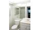 Bathroom featuring a toilet, sink, vanity and walk-in shower at 101 Cambridge Trl # 205, Sun City Center, FL 33573