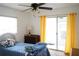 Bedroom with ceiling fan, and sliding door leading to enclosed porch area at 101 Cambridge Trl # 205, Sun City Center, FL 33573