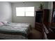Serene bedroom with a comfortable bed, dresser, and a bright window providing natural light at 101 Cambridge Trl # 205, Sun City Center, FL 33573