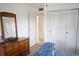 Cozy bedroom boasts ample closet space and dresser with large mirror at 101 Cambridge Trl # 205, Sun City Center, FL 33573