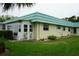 Charming exterior view of a well-maintained home with lush landscaping at 101 Cambridge Trl # 205, Sun City Center, FL 33573