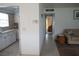 Bright hallway connecting the living area and kitchen with a glimpse into other rooms with tasteful decor at 101 Cambridge Trl # 205, Sun City Center, FL 33573