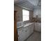 Well-maintained kitchen with ample counter space, white cabinets, and modern appliances, perfect for cooking at 101 Cambridge Trl # 205, Sun City Center, FL 33573