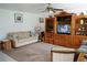 Inviting living room with plush sofa, classic wooden furniture, and a cozy ambiance enhanced by soft lighting at 101 Cambridge Trl # 205, Sun City Center, FL 33573