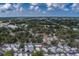 An aerial view shows the neighborhood landscape with lush green trees and clear blue skies at 102 7Th Se Ave, Largo, FL 33771