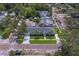 A well-manicured property featuring a lush lawn, mature trees, and situated on a charming brick-paved street at 102 7Th Se Ave, Largo, FL 33771