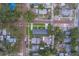 A beautiful aerial view shows this home and neighborhood with lush greenery and brick streets at 102 7Th Se Ave, Largo, FL 33771