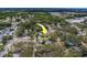 A tranquil residential area, with a well-maintained home marked by a yellow arrow amid lush greenery and quiet streets at 102 7Th Se Ave, Largo, FL 33771