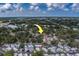 An aerial neighborhood shot shows the home surrounded by green mature trees at 102 7Th Se Ave, Largo, FL 33771