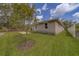 Charming home exterior with a well-maintained lawn, side yard, and partial privacy fence at 102 7Th Se Ave, Largo, FL 33771