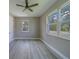 This bedroom features wood-look flooring, neutral paint and plenty of natural light from the double windows and modern ceiling fan at 102 7Th Se Ave, Largo, FL 33771